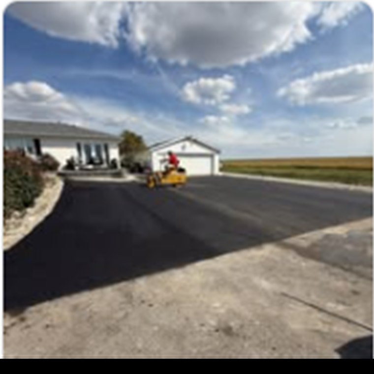 Fresh blacktop driveway beside a rural Indiana home